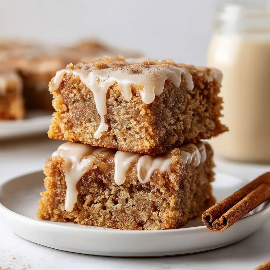 A stack of gooey blondies with glaze and hints of cinnamon.